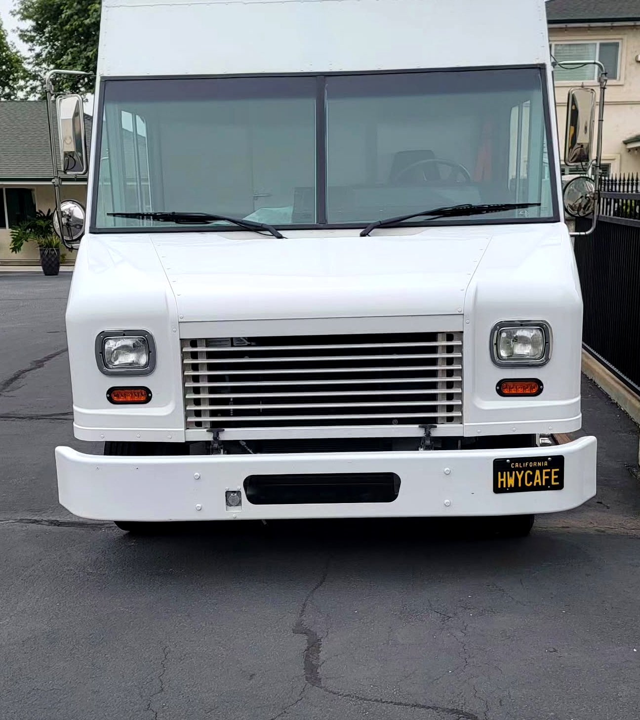 Front of truck with California HWYCAFE plate on white face